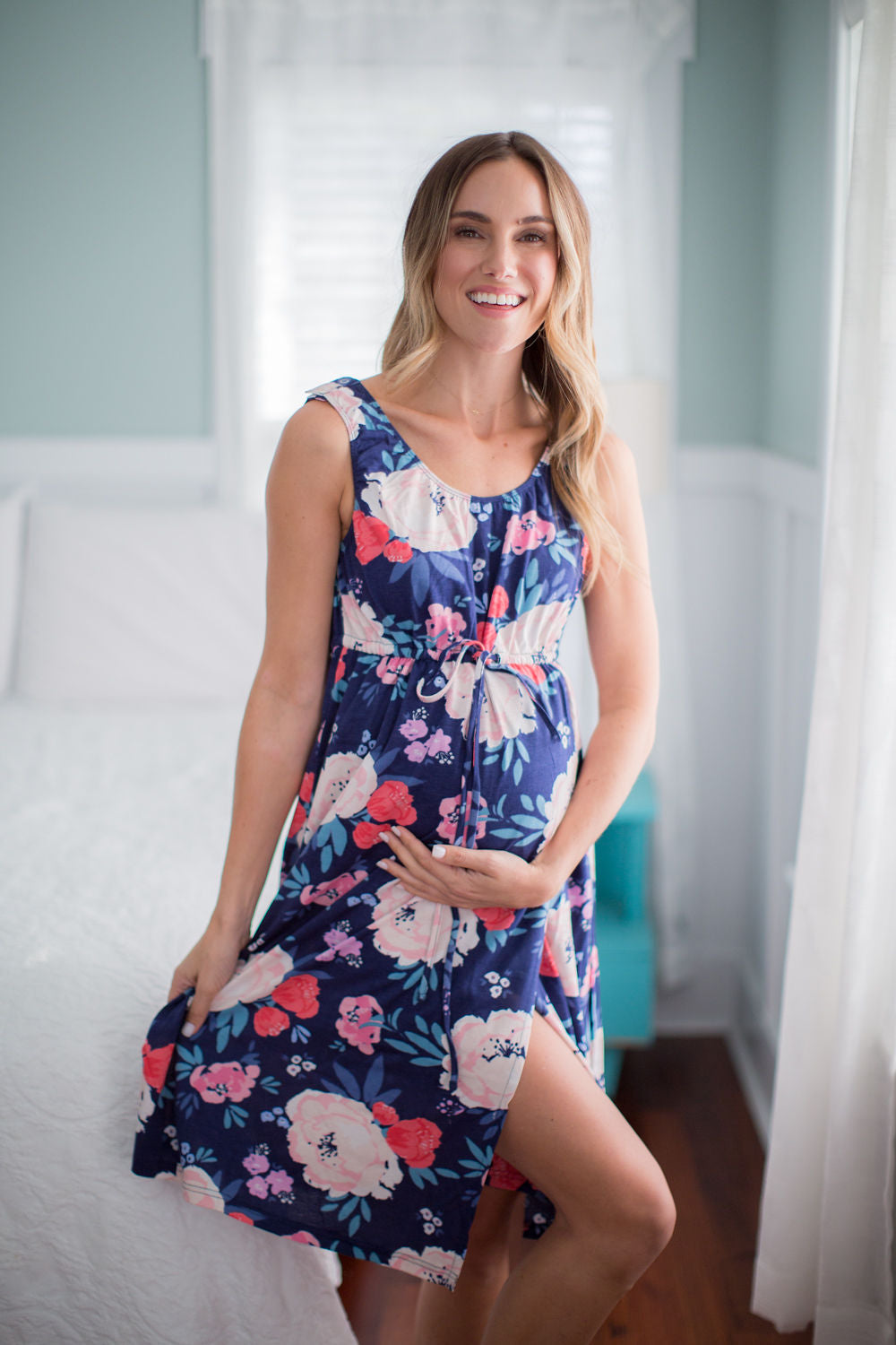 Annabelle labor gown with navy background and a flowered print. Labor gowns are an excellent option for delivery with an elastic waist, snap shoulders, and a wrap waist for coverage.