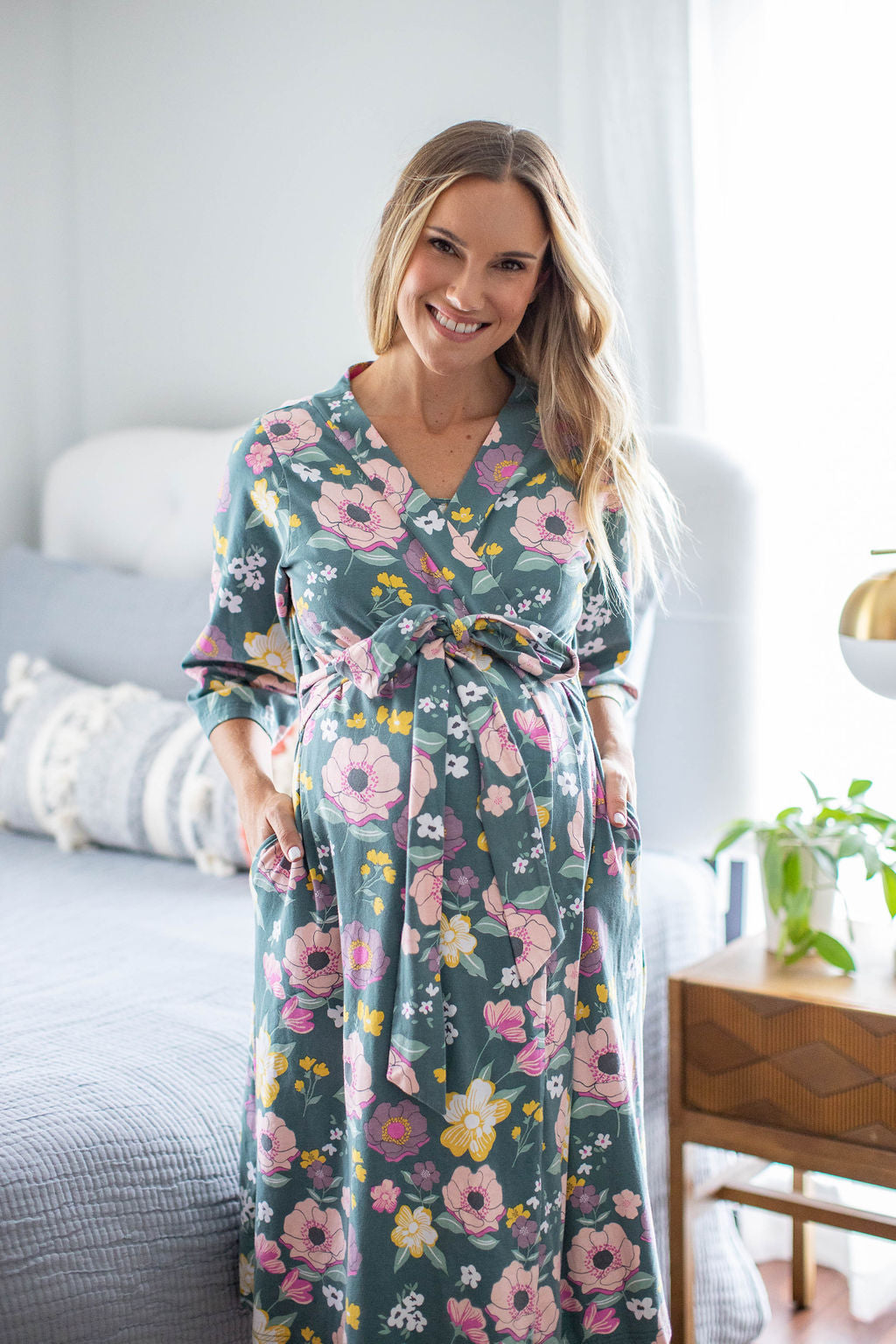 Maternity robe for mom-to-be with pink and yellow flowers against a deep green background. The Charlotte print is perfect for bold, feminine moms. 