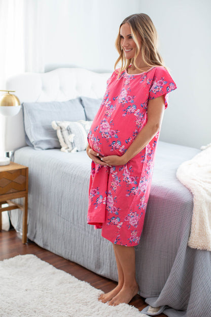 Rose print: pink and blue petaled flowers against a bright, fuschia background. Pink neck trim. Gownies are made as an alternative to generic hospital gowns.
