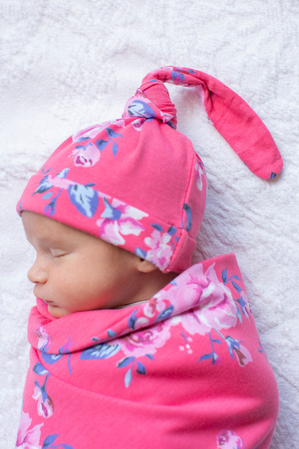 Fuschia pink background with light pink flowers, Rose print. Double-lined swaddle and hat set for ultimate coziness.