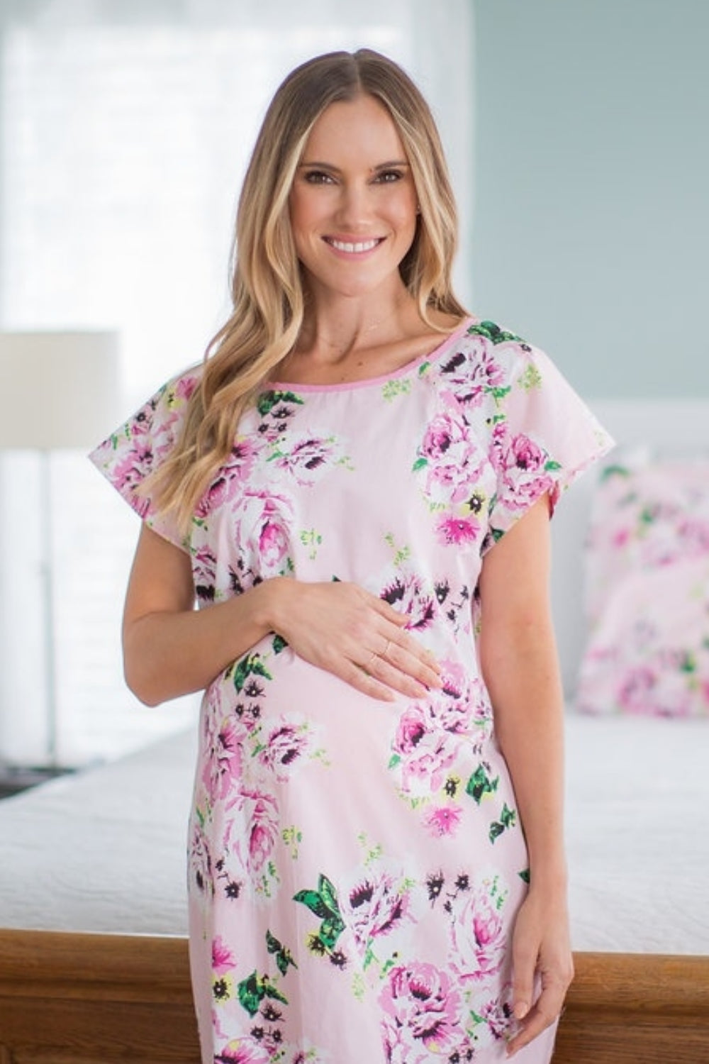 Pink floral printed hospital gown. Made with 100% cotton, this gown has shoulder snaps and back snaps for full coverage.